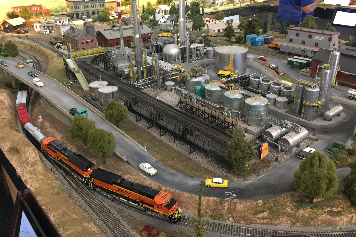 BNSF passing by an oil refinery at the HO scale North County Model Railroad Society model railroad layout. BNSF passing by an oil refinery at the HO scale North County Model Railroad Society model railroad layout.